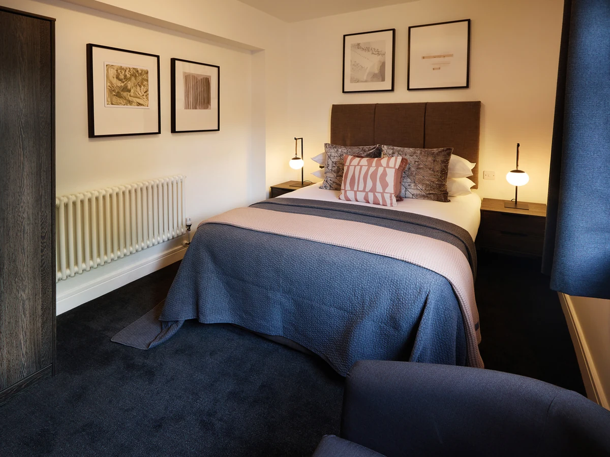 Elegant bedroom with purple accent wall painted by Sheffield Decorators