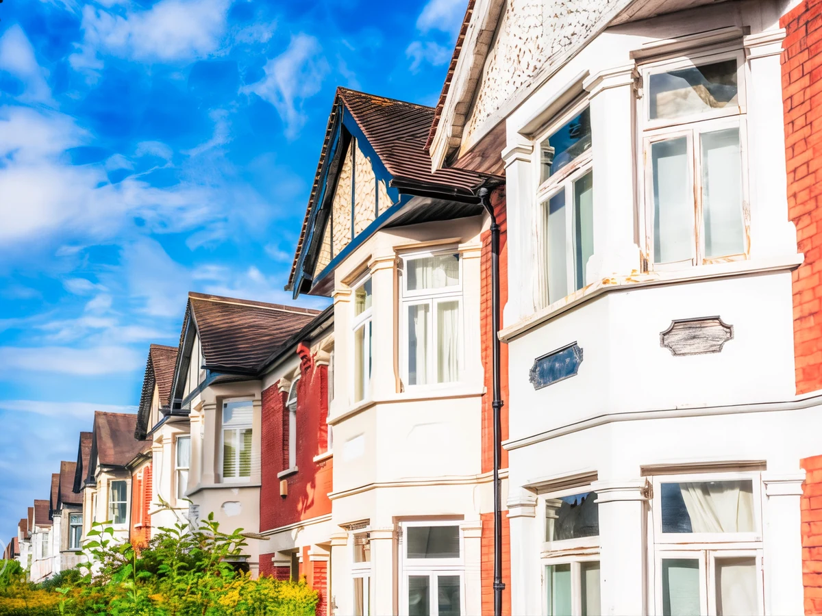 Red brick property with white painted window frames by Sheffield Decorators