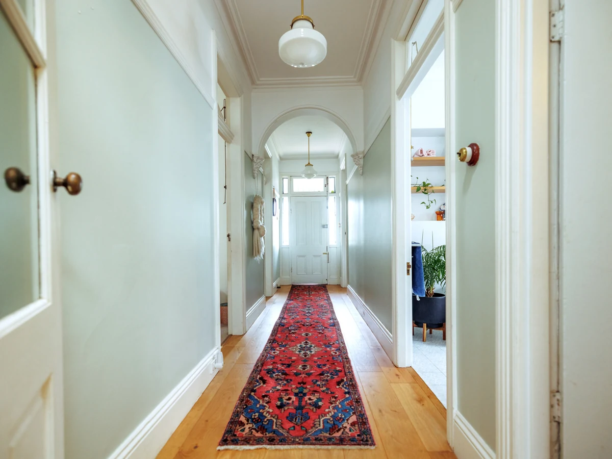 White hallway with wood flooring painted by Sheffield Decorators
