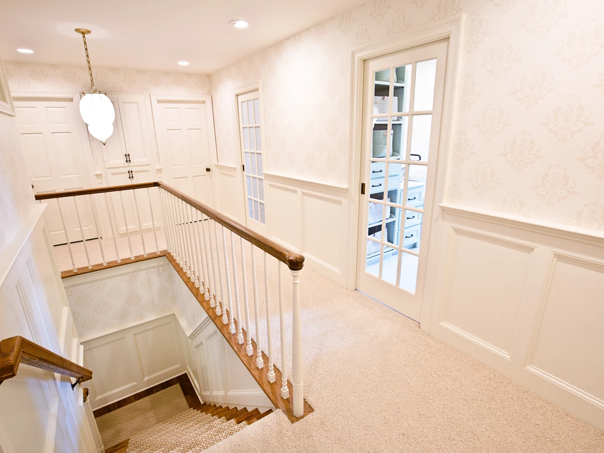 Staircase painting Sheffield — bright upstairs landing with painted balusters and handrail