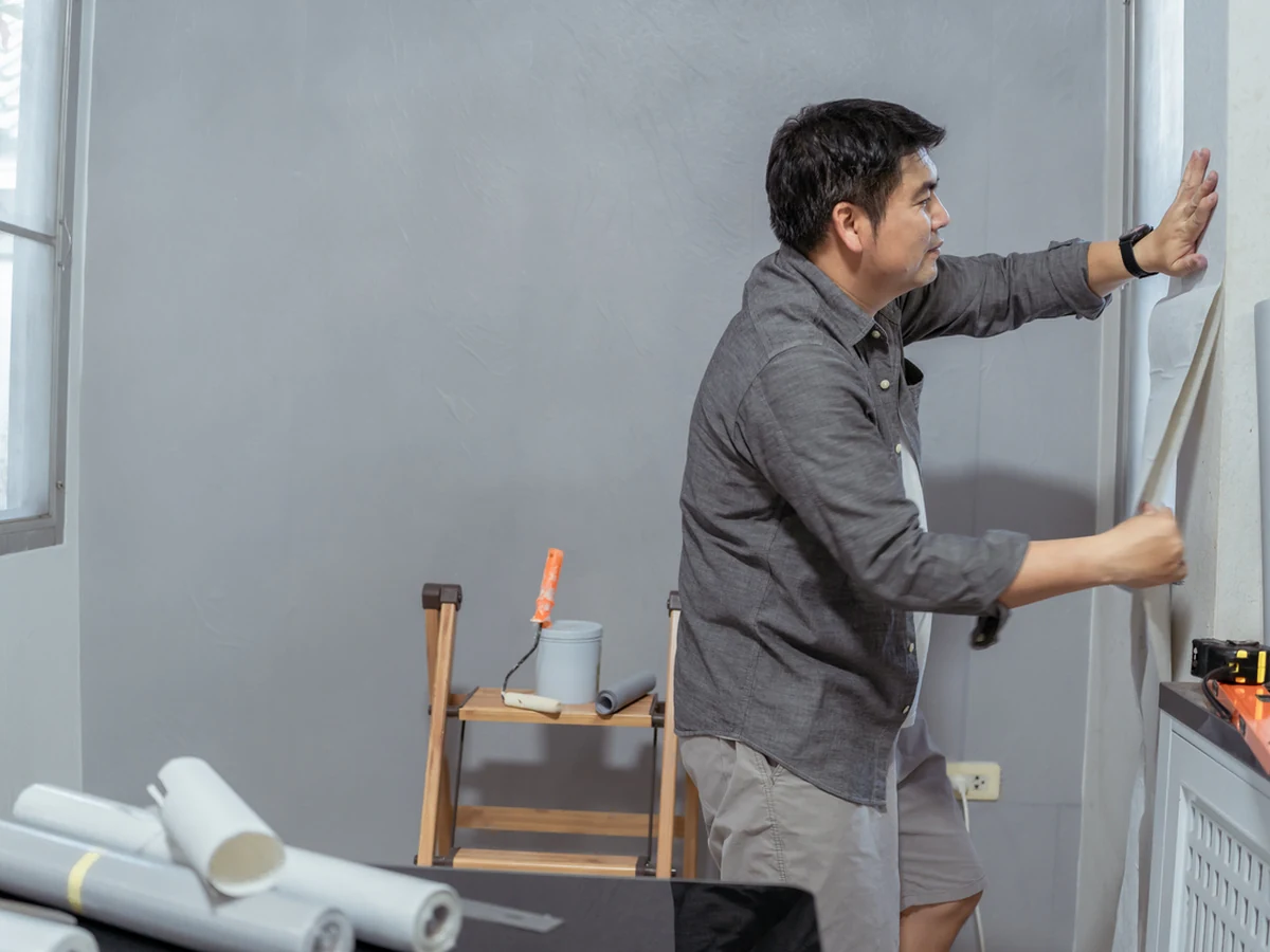 Wallpaper installer applying wallpaper in Sheffield by Sheffield Decorators, professional wallpapering service